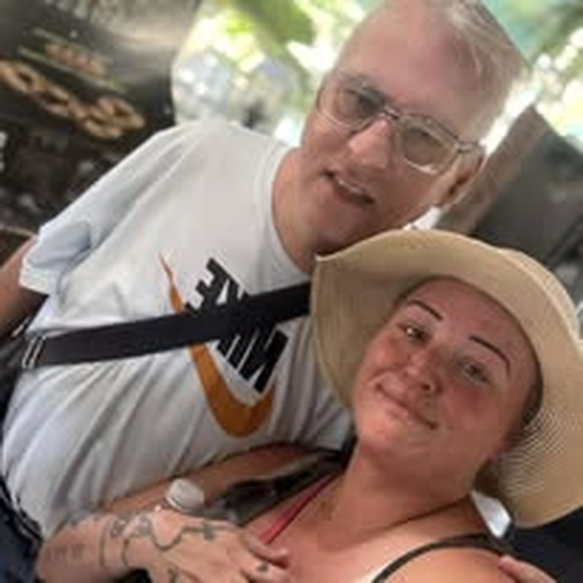 A couple smiling together during a community outing.