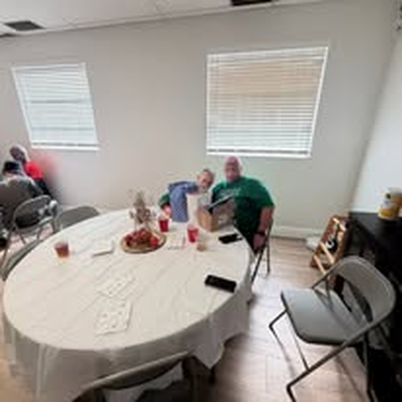 Guests gathered around round tables for a holiday dinner.