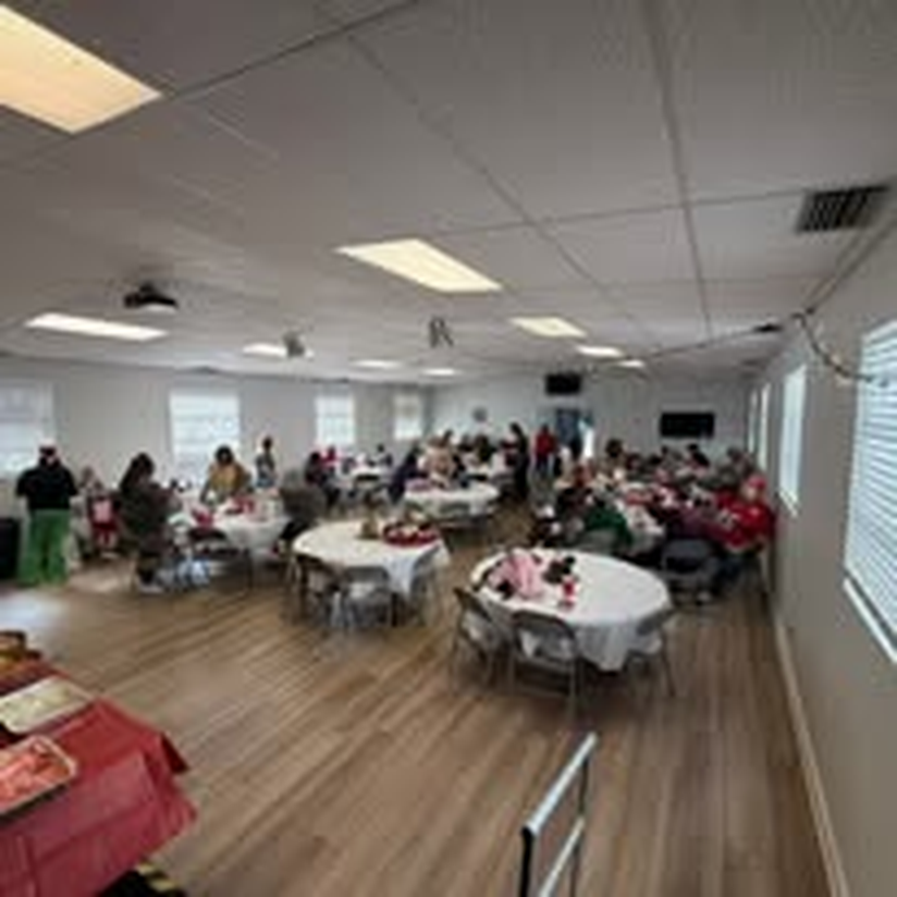 A full room of guests at the holiday celebration.