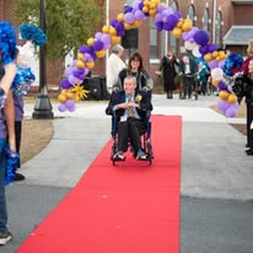 An individual in a wheelchair with all eyes on him at the gala.