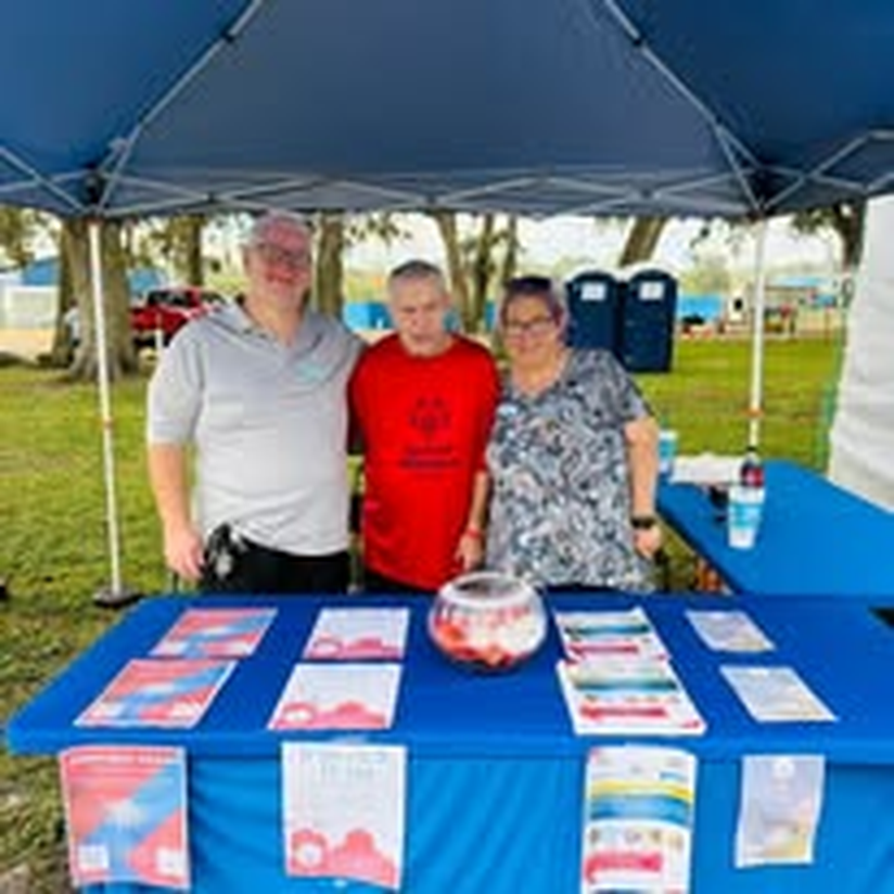 Staff volunteering at the Be The Change NE FL community outreach tent.