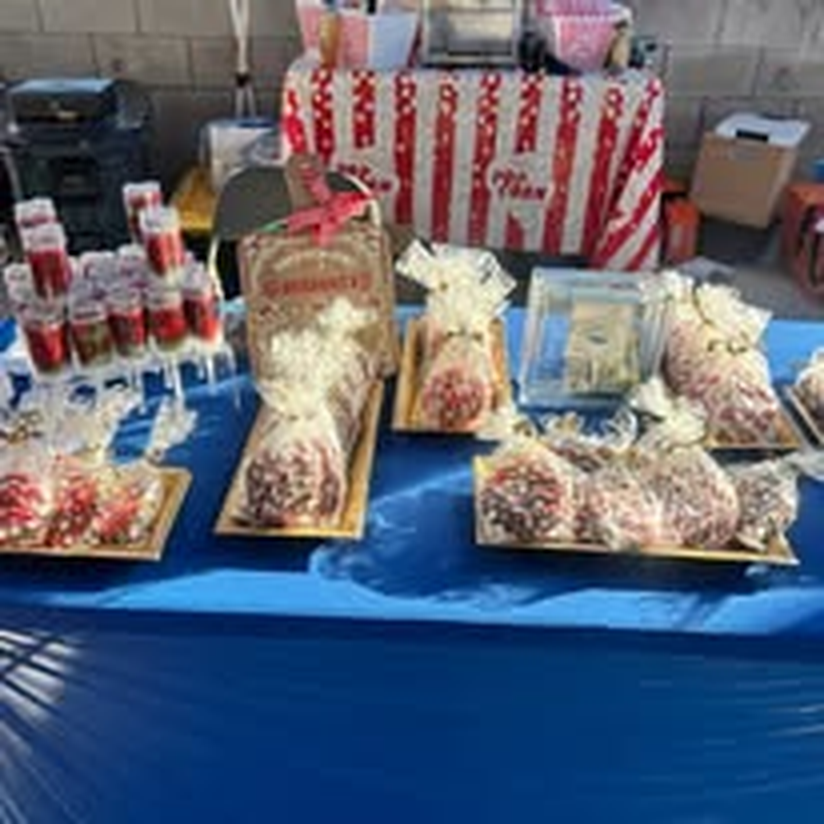 Kettle corn and bagged treats for sale at a community fair.