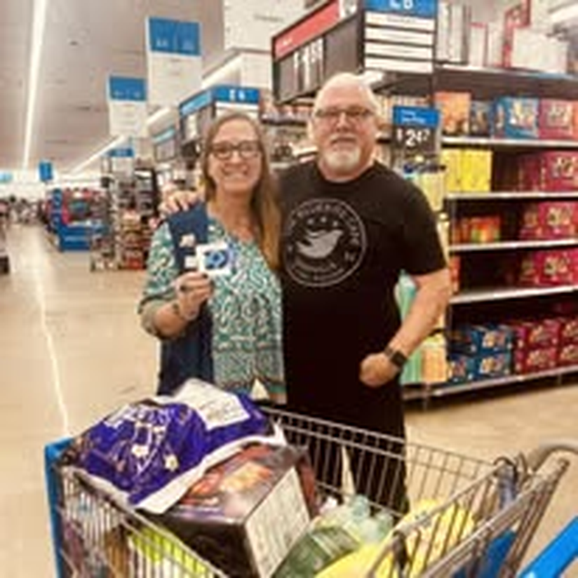 A couple shopping together for community supplies.