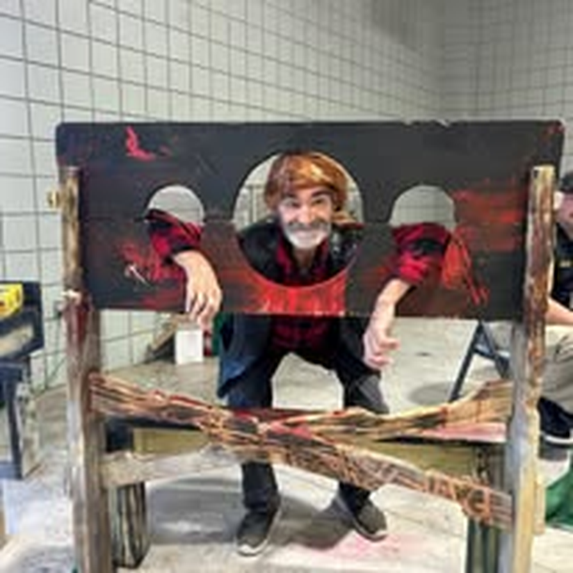 A child playing along at the Halloween photo booth prop.